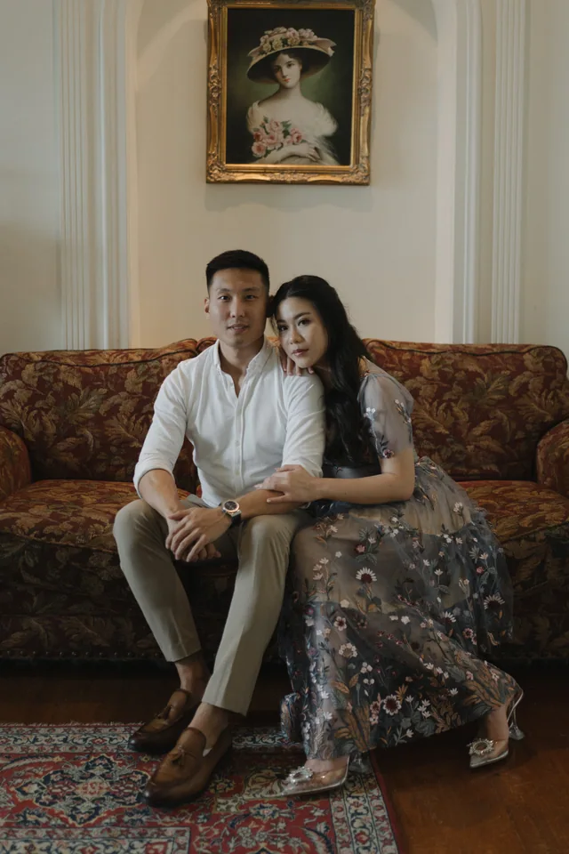Mauric and Nadya sitting together in a classic interior